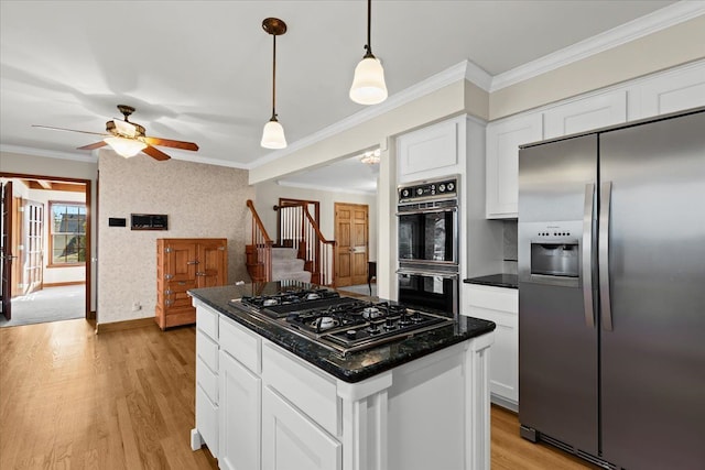 kitchen with wallpapered walls, stovetop with downdraft, light wood-style floors, stainless steel fridge, and dobule oven black