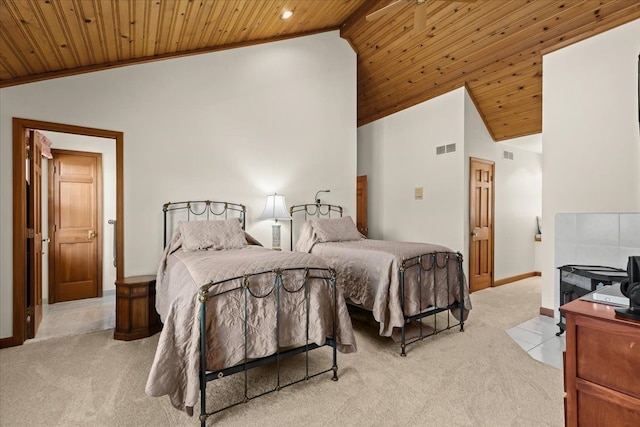 bedroom with wooden ceiling, light tile patterned floors, visible vents, and light carpet