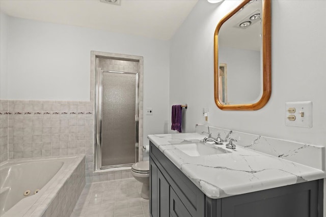 bathroom with tile patterned flooring, toilet, a whirlpool tub, a stall shower, and vanity