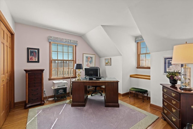 office featuring plenty of natural light, lofted ceiling, and wood finished floors