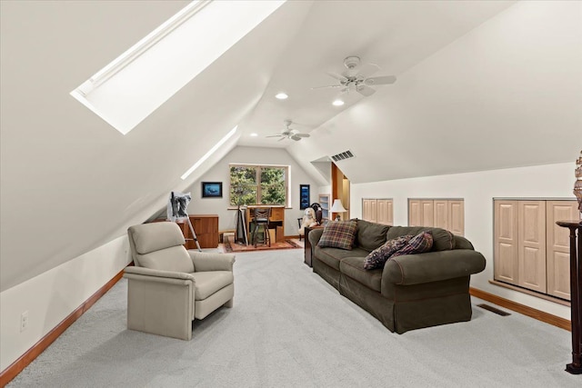 carpeted living area with recessed lighting, visible vents, vaulted ceiling with skylight, and baseboards