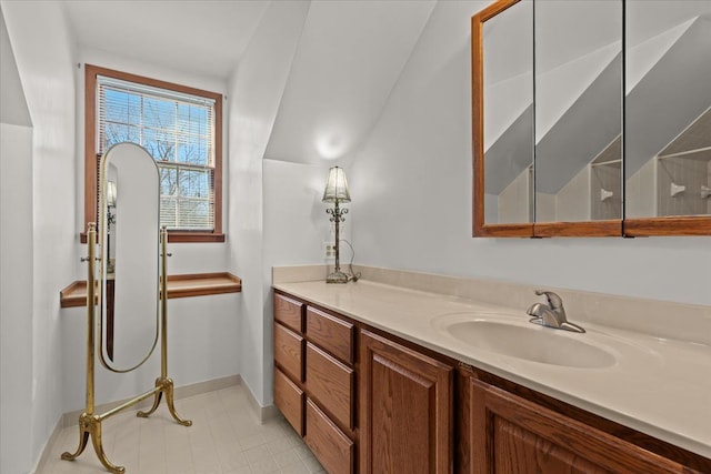 bathroom with vanity and baseboards