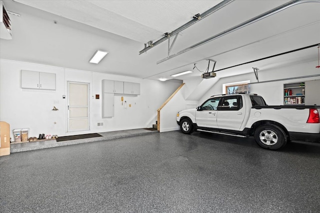 garage with a garage door opener and baseboards