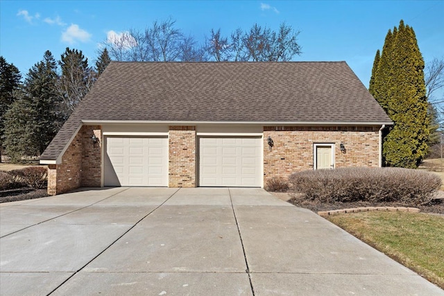 view of front of house featuring a garage, brick siding, concrete driveway, and a shingled roof