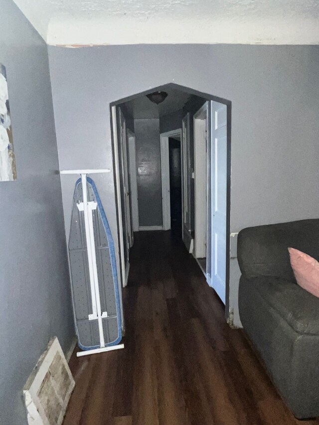 hall featuring baseboards and wood finished floors