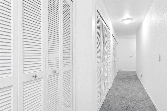 corridor featuring carpet floors and baseboards