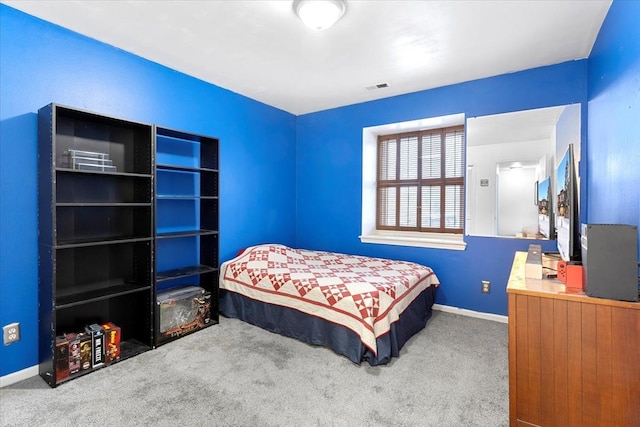 carpeted bedroom featuring visible vents and baseboards