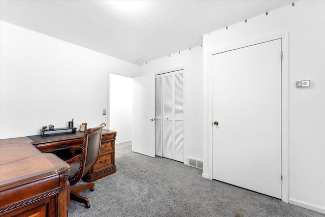 carpeted office space featuring visible vents