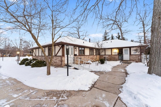 view of front of property featuring stone siding and stucco siding