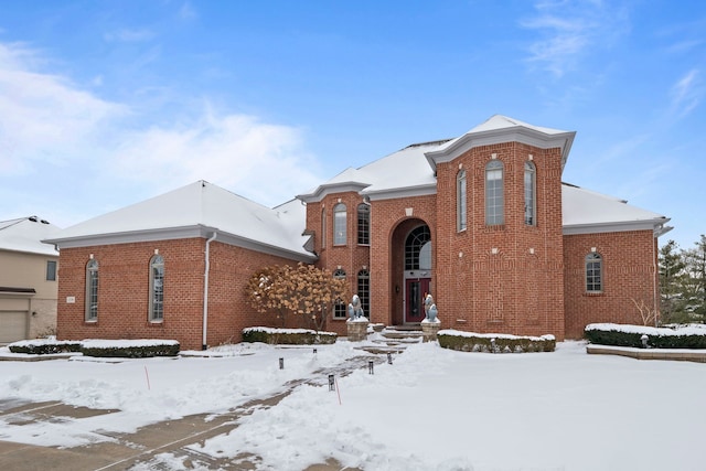 view of front of property featuring a garage and brick siding