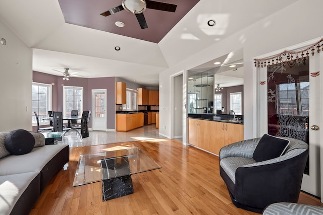 living room featuring recessed lighting, ceiling fan, light wood-style flooring, and baseboards