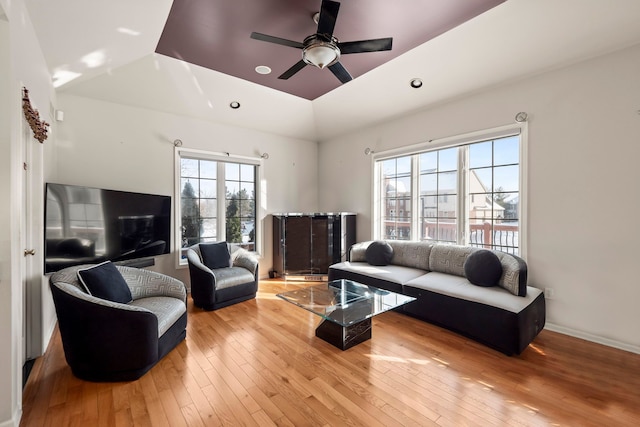 living room with lofted ceiling, recessed lighting, ceiling fan, baseboards, and hardwood / wood-style flooring