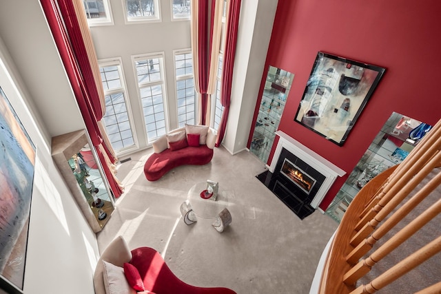 carpeted living room with a fireplace with flush hearth