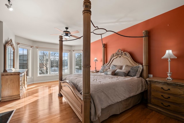 bedroom with hardwood / wood-style flooring and baseboards