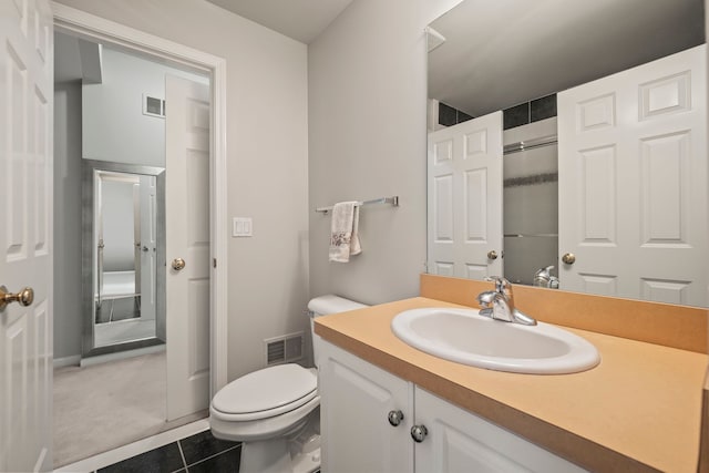 bathroom with toilet, tile patterned floors, visible vents, and vanity