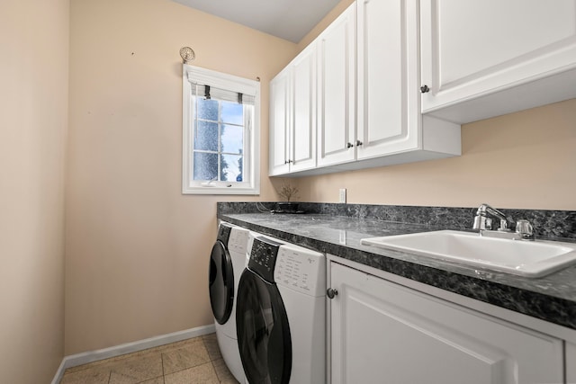 clothes washing area with cabinet space, baseboards, washing machine and dryer, a sink, and light tile patterned flooring