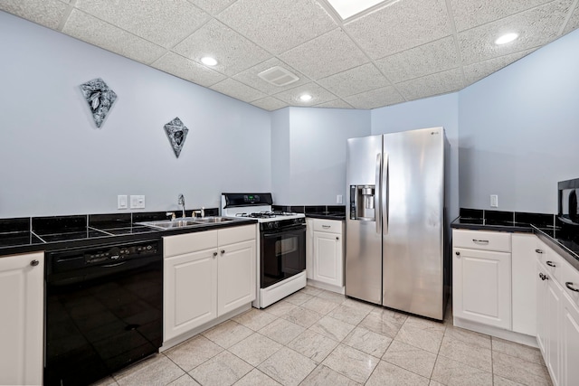 kitchen featuring range with gas cooktop, black dishwasher, dark countertops, a sink, and stainless steel fridge with ice dispenser