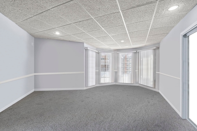 carpeted spare room featuring recessed lighting, a drop ceiling, and baseboards