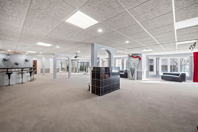 interior space with arched walkways, carpet, a paneled ceiling, ornate columns, and recessed lighting