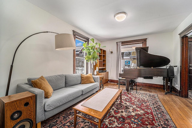 living area featuring wood-type flooring and baseboards