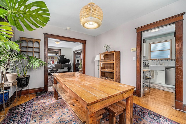 dining room with light wood finished floors and baseboards