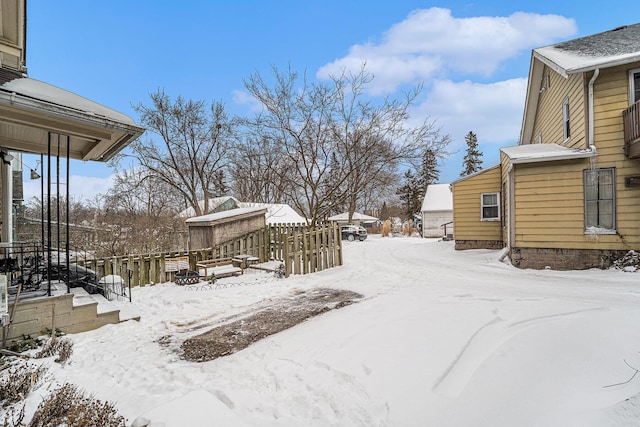 yard layered in snow with fence