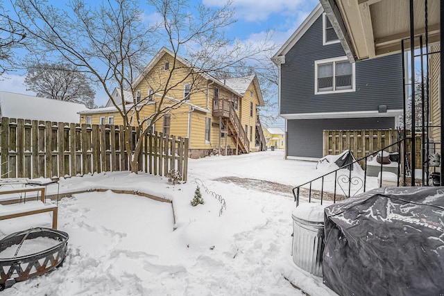 yard layered in snow featuring fence