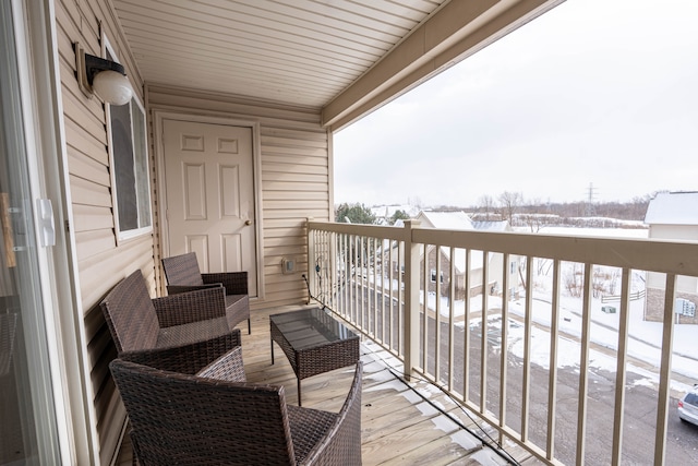 view of snow covered back of property