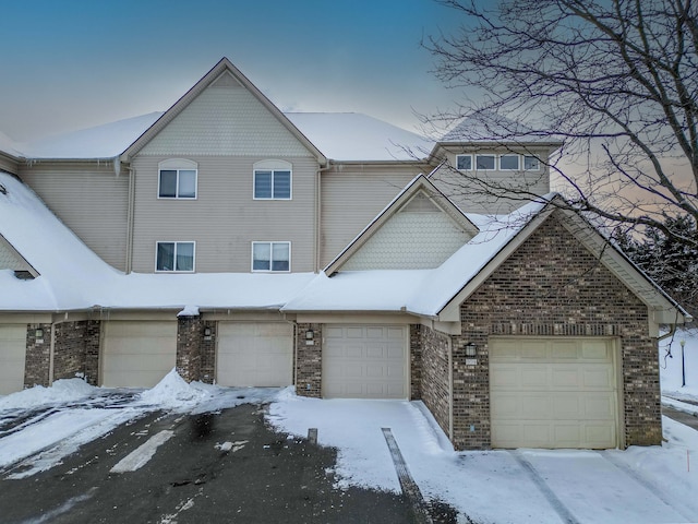 townhome / multi-family property featuring brick siding