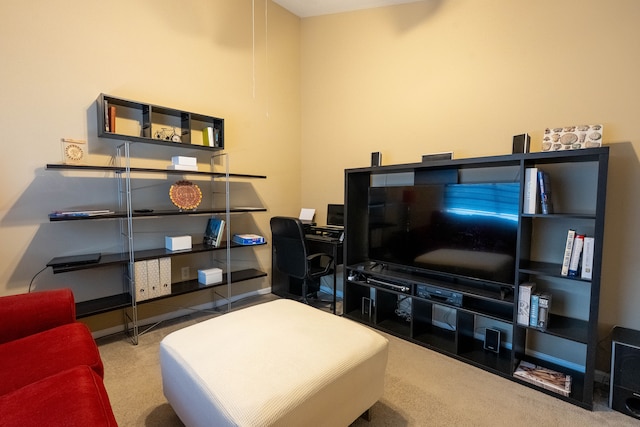 carpeted living area featuring baseboards