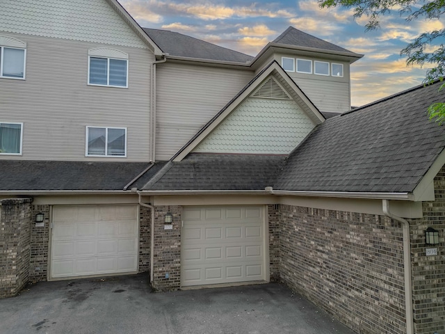 806 Brandon Ave, Pontiac, MI 48340 - view of front of home with driveway, brick siding, an attached garage, and a shingled roof