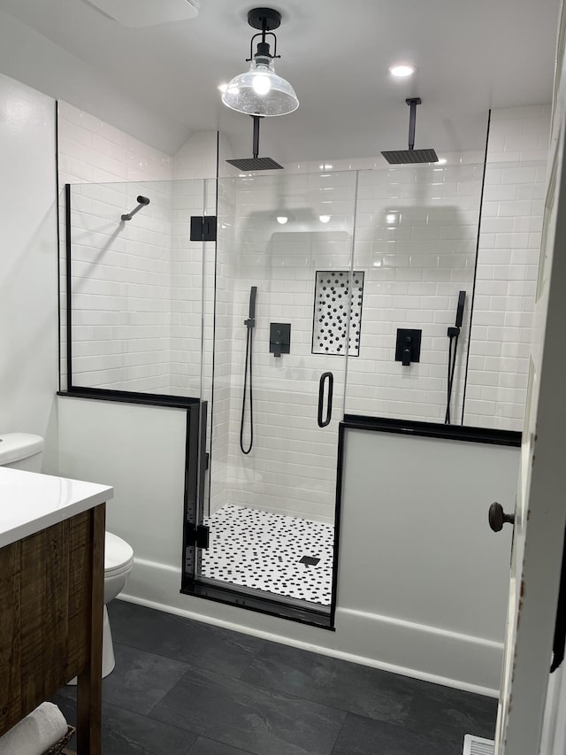 full bath with toilet, a shower stall, lofted ceiling, and vanity