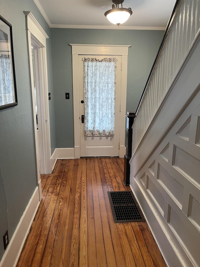 entrance foyer with baseboards, crown molding, and hardwood / wood-style floors