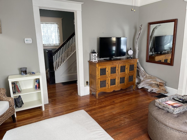 living area with wood-type flooring and stairway