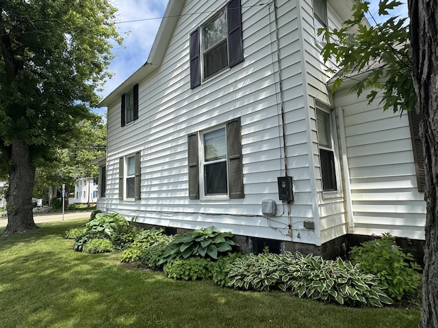 view of property exterior with a lawn