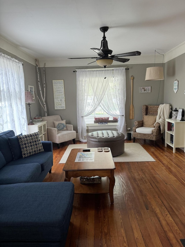 living area featuring ornamental molding, hardwood / wood-style flooring, and a ceiling fan