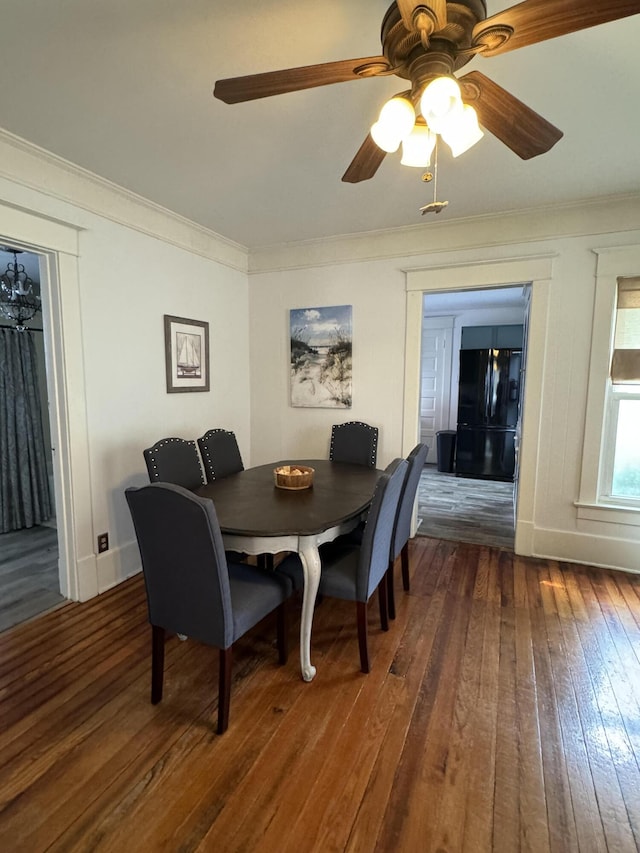 dining area featuring ornamental molding and hardwood / wood-style flooring