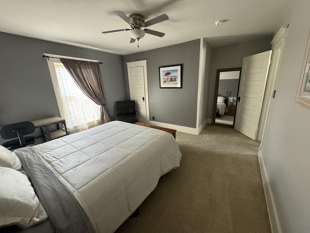 carpeted bedroom featuring baseboards and a ceiling fan