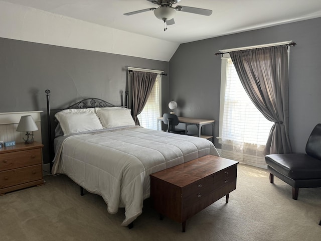 bedroom with light carpet, vaulted ceiling, and ceiling fan