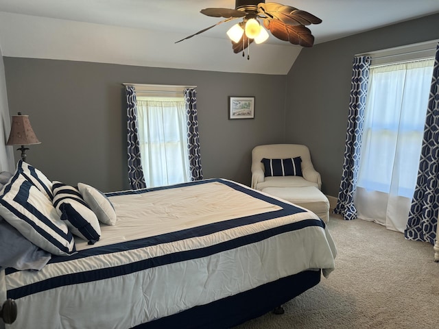 bedroom featuring lofted ceiling, carpet flooring, and a ceiling fan