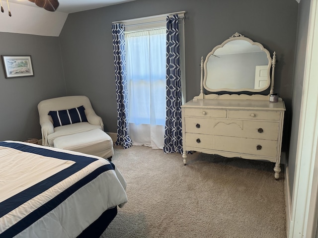 bedroom with vaulted ceiling and carpet flooring