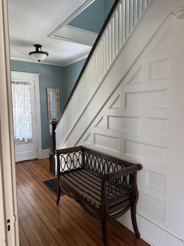 entrance foyer featuring hardwood / wood-style flooring, baseboards, stairs, and ornamental molding