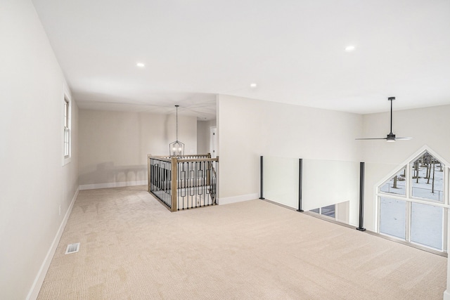 spare room with recessed lighting, baseboards, visible vents, and light colored carpet