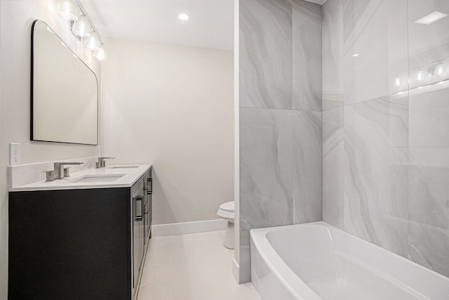 bathroom featuring toilet, a sink, baseboards, a bath, and double vanity