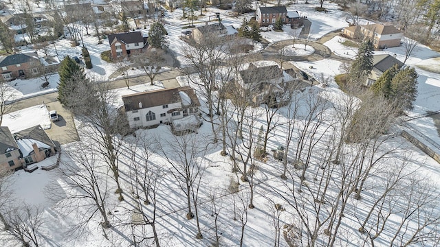 snowy aerial view with a residential view