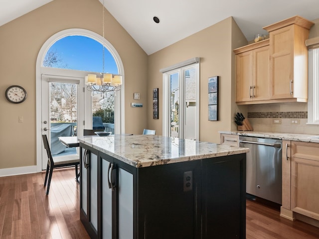 kitchen with light brown cabinetry, backsplash, stainless steel dishwasher, a center island, and dark wood-style flooring