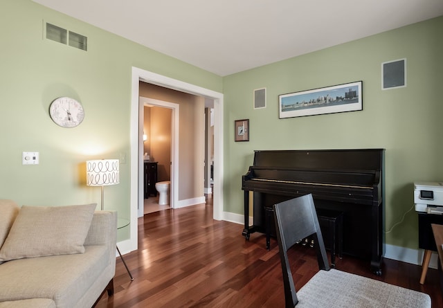 sitting room featuring visible vents, baseboards, and wood finished floors