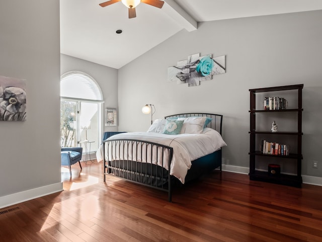 bedroom with lofted ceiling with beams, wood finished floors, baseboards, and visible vents