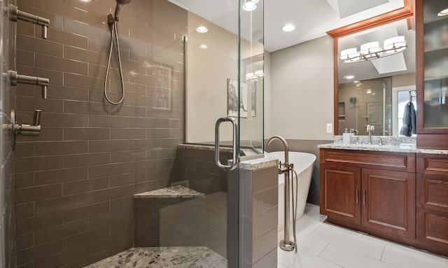 bathroom featuring tile patterned floors, a wainscoted wall, a stall shower, a freestanding bath, and vanity