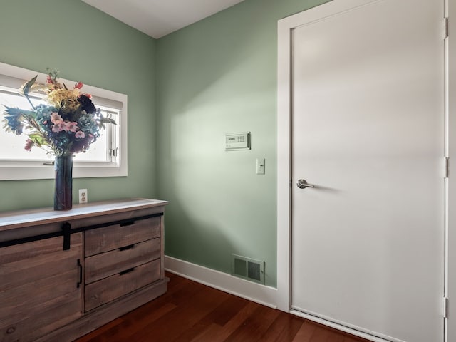 bathroom featuring wood finished floors, visible vents, and baseboards